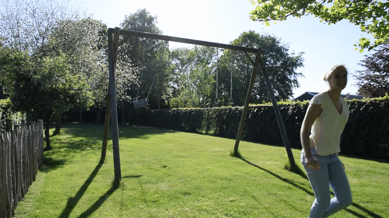 Nienke jumping on swing